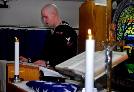 US Navy 090408-N-9928E-008 Culinary Specialist 3rd Class Hugh Craig, from Bremerton, Wash., eulogizes his grandfather.h