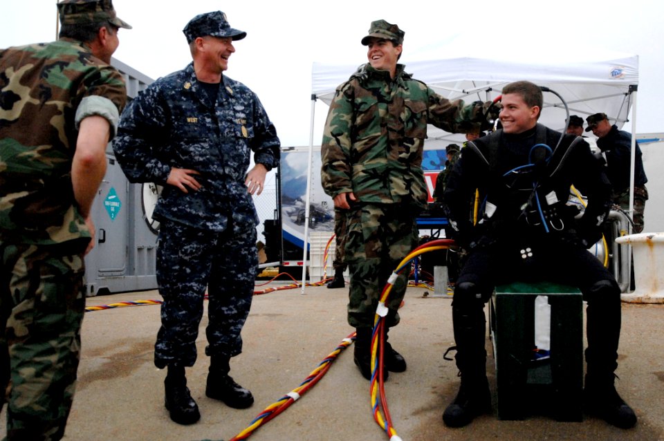 US Navy 090415-N-9818V-175 Master Chief Petty Officer of the Navy (MCPON) Rick West speaks with his son, Navy Diver 3rd Class Zach West, during a visit with Sailors from Mobile Diving and Salvage Unit (MDSU) 2 at Naval Amphibio