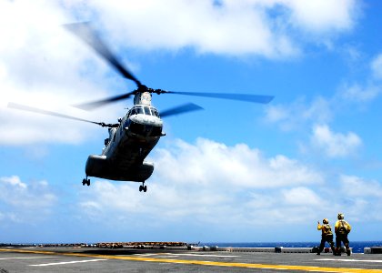 US Navy 090410-N-9950J-005 Aviation Boatswain's Mate (Handling) Airman Emily McCann, left, from Redlands, Calif., and Aviation Boatswain's Mate (Handling) Mario Teasley, from Charlotte, N.C., direct the landing of a CH-46E Sea