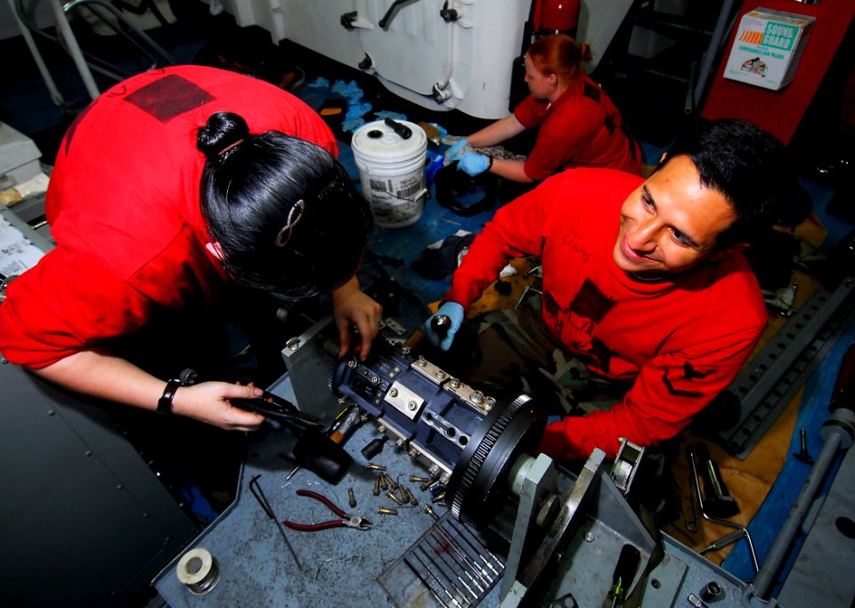 US Navy 090416-N-6597H-130 Fire Controlman 3rd Class Mirko Clarke, and Fire Controlman 2nd Class Geneva Myers conduct scheduled maintenance on a Phalanx Close In Weapons System aboard the aircraft carrier USS John C. Stennis (C