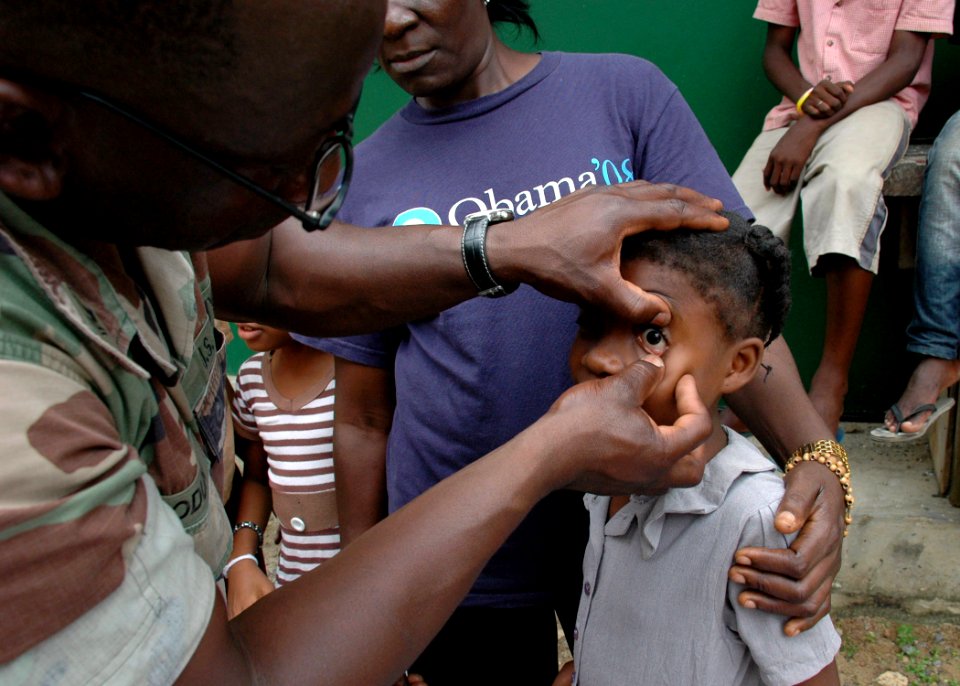 US Navy 090416-N-1655H-126 Hospital Corpsman 2nd Class Sule Abiodun, a member of the Africa Partnership Station Nashville Department of Defense medical team, tests the vision of a school girl in Libreville