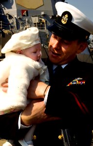 US Navy 090409-N-6700F-002 Chief Electrician's Mate Gregory Outman from the guided-missile destroyer USS Mahan (DDG 72), reunites with his three-month old daughter