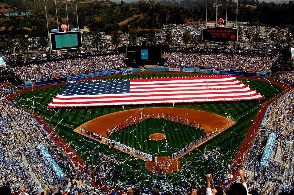 US Navy 090413-N-9706M-124 Sailors and Marines unfurl a football field-sized American flag at Dodger Stadium during the pre-game activities before a Major League Baseball game between the Los Angeles Dodgers and the San Francis