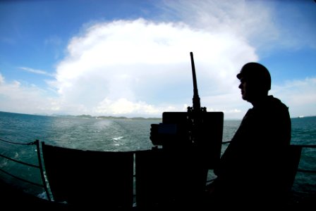 US Navy 090413-N-0096C-004 Gunner's Mate 3rd Class Aaron Sanneman, from Clarke, Wis., mans a .50-caliber machine gun on the fantail of the aircraft carrier USS John C. Stennis (CVN 74)