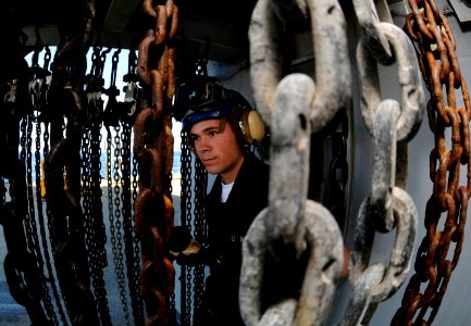 US Navy 090415-N-7280V-124 Seaman Joseph Bean mans a sound powered telephone aboard the amphibious command ship USS Blue Ridge (LCC 19) during a crash and salvage drill