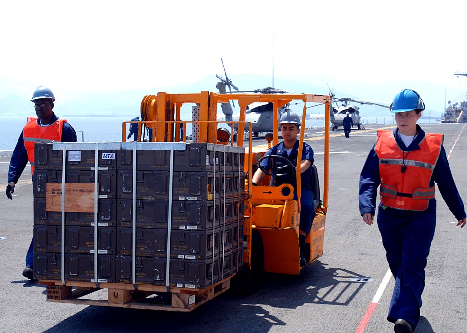US Navy 090415-N-5215E-052 viation Ordnancemen move pallets of ammunition cartridges aboard the amphibious assault ship USS Essex (LHD 2) to support the 31st Marine Expeditionary Unit (31st MEU) role in Balikatan '09