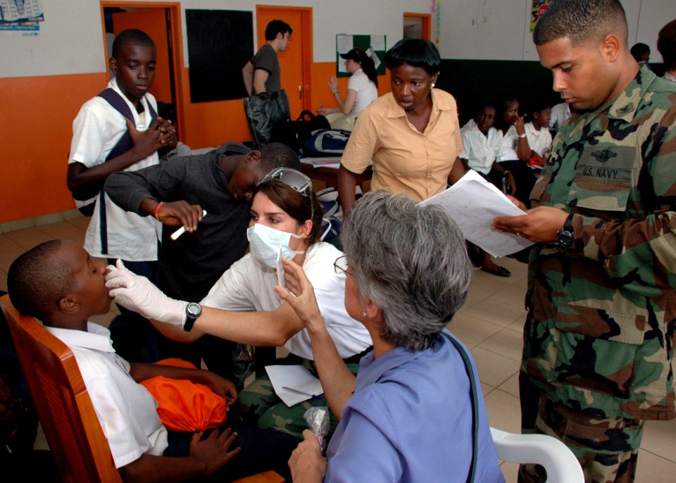 US Navy 090416-N-1655H-145 Lt. Cmdr. Shay Ramzi, a dentist with the Africa Partnership Station Nashville Department of Defense medical and dental team, gives an oral exam to a child at the Centre Arc-en-Ciel children's shelter