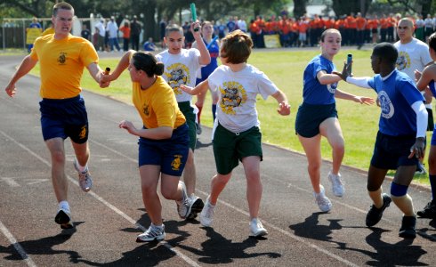 US Navy 090417-N-8848T-321 Navy Junior ROTC cadets hand off batons during a 8x220-yard Oval Relay during the 2009 NJROTC National Academic, Athletic and Drill competition at Naval Air Station Pensacola photo