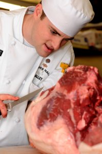 US Navy 090416-N-4515N-021 Culinary Specialist 1st Class William Foster, assigned to Cross Hall Galley in Groton, Conn., butchers a slab of beef during the first Navy Region Mid-Atlantic Iron Chef Competition at Naval Station N