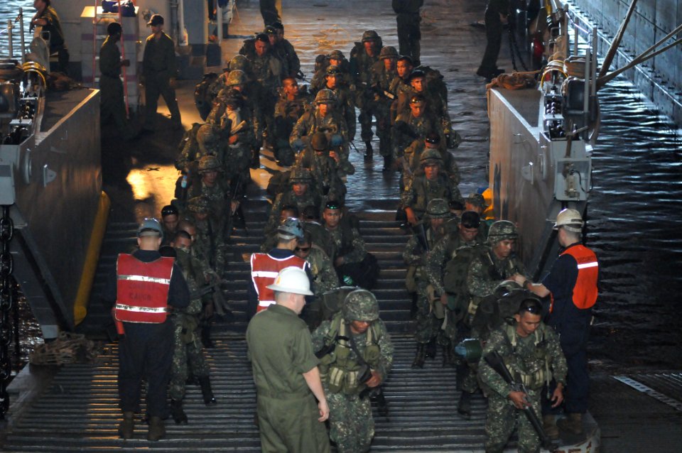 US Navy 090414-N-4010S-042 Armed Forces of the Philippines Marines assigned to the 38th Marine Company depart a landing craft utility and check in with combat cargo personnel assigned to the amphibious assault ship USS Essex (L