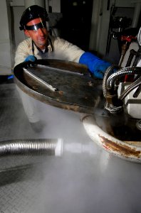 US Navy 090414-N-6597H-023 Machinist Mate 3rd Class Thomas Armstrong, from Denver, Colo., transfers liquid oxygen into a liquid oxygen servicing cart before transferring it to the flight deck of the Nimitz-class aircraft carrie