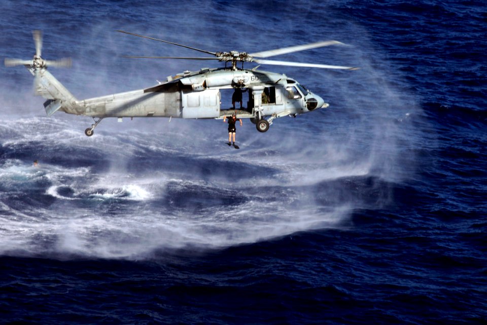 US Navy 090416-N-9150R-255 A search and rescue swimmer jumps from an MH-60S Sea Hawk helicopter