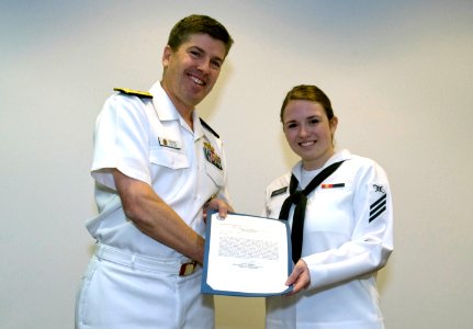 US Navy 090415-N-5319A-007 Mass Communication Specialist Seaman Kathleen O'Keefe is congratulated by the Rear Adm. Frank Thorp, Chief of Information, during her graduation ceremony at the Defense Information School at Ft. Georg