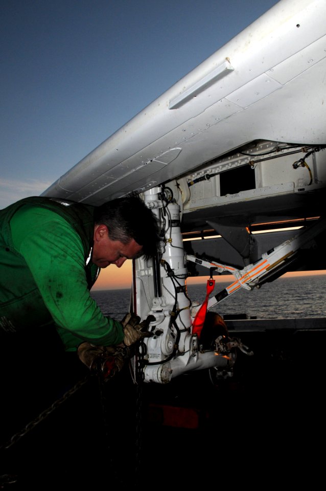 US Navy 090418-N-7730P-009 A civilian contractor ties down a T-45 Goshawk training aircraft assigned to Training Wing (TW) 2