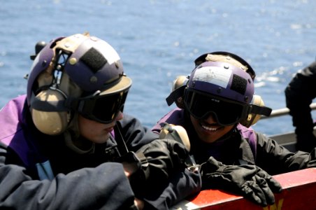 US Navy 090417-N-3610L-341 Aviation Boatswain's Mate (Fuels) Airman Christopher Levosky, left, and Aviation Boatswain's Mate (Fuels) Airman Jose Lopez stand by on a catwalk during flight operations aboard the aircraft carrier U