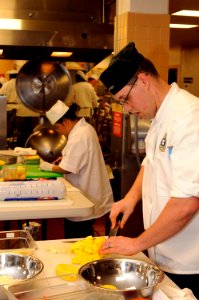 US Navy 090416-N-4515N-058 Culinary Specialist 2nd Class Caleb Garner assigned to Northwest Annex Galley at Naval Station Norfolk, slices squash during the first Navy Region Mid-Atlantic Iron Chef Competition at Naval Station N