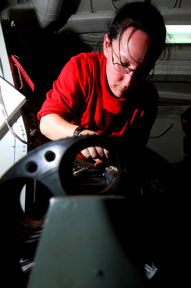 US Navy 090416-N-6597H-091 Fire Controlman 2nd Class Geneva Myers, from Kinston, N.C., conducts scheduled maintenance on a Phalanx Close In Weapons System aboard the aircraft carrier USS John C. Stennis (CVN 74)