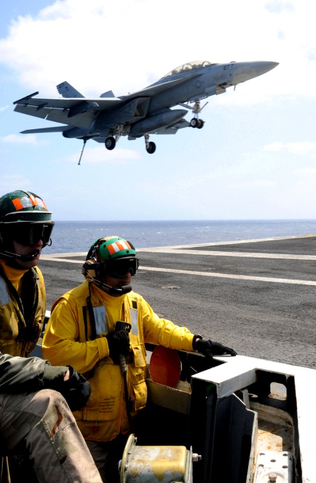 US Navy 090416-N-7730P-238 Lt. William Eastham and Lt. Oscar Flores, shooters aboard the aircraft carrier USS Ronald Reagan (CVN 76), stand in the gear pit