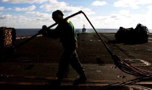 US Navy 090418-N-6538W-128 Lance Cpl. Kyle Ferner, from Orlando, Fla., clears cargo pendants from the flight deck aboard the Nimitz-class aircraft carrier USS John C. Stennis (CVN 74)