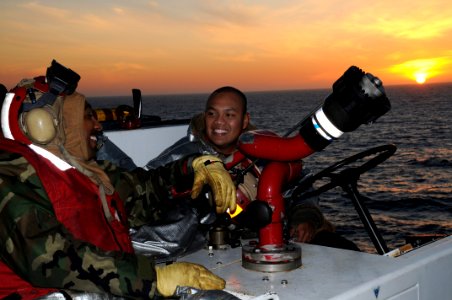 US Navy 090418-N-7730P-015 Sailors share a laugh as the sun sets on the final day of carrier qualification aboard the aircraft carrier USS Ronald Reagan (CVN 76)