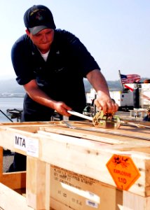 US Navy 090416-N-5215E-038 Aviation Ordnanceman 3rd Class Gregory Castelin prepares an ammunition pallet for crane pickup during an ammunition offload from the amphibious assault ship USS Essex (LHD 2)