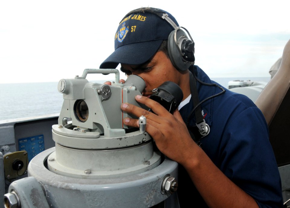 US Navy 090417-N-3666S-015 Operations Specialist 3rd Class Jesse Salgado looks through a Polaris on the bridge of the guided-missile frigate USS Reuben James (FFG 57)