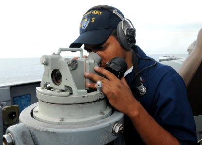 US Navy 090417-N-3666S-015 Operations Specialist 3rd Class Jesse Salgado looks through a Polaris on the bridge of the guided-missile frigate USS Reuben James (FFG 57)