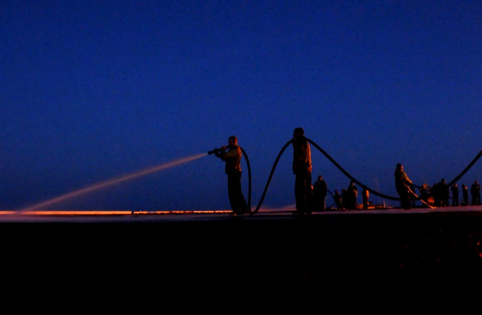 US Navy 090418-N-7730P-026 Sailors assigned to air department man fire hoses during a nighttime scrub exercise on the flight deck of the aircraft carrier USS Ronald Reagan (CVN 76)