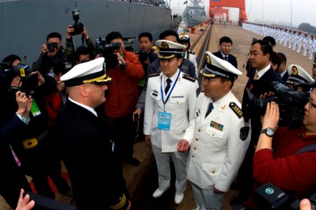 US Navy 090419-N-1251W-118 Cmdr. Richard Dromerhauser, commanding officer of the guided-missile destroyer USS Fitzgerald (DDG 62), speaks with officers of the People's Liberation Army Navy after Fitzgerald's arrival in the port photo