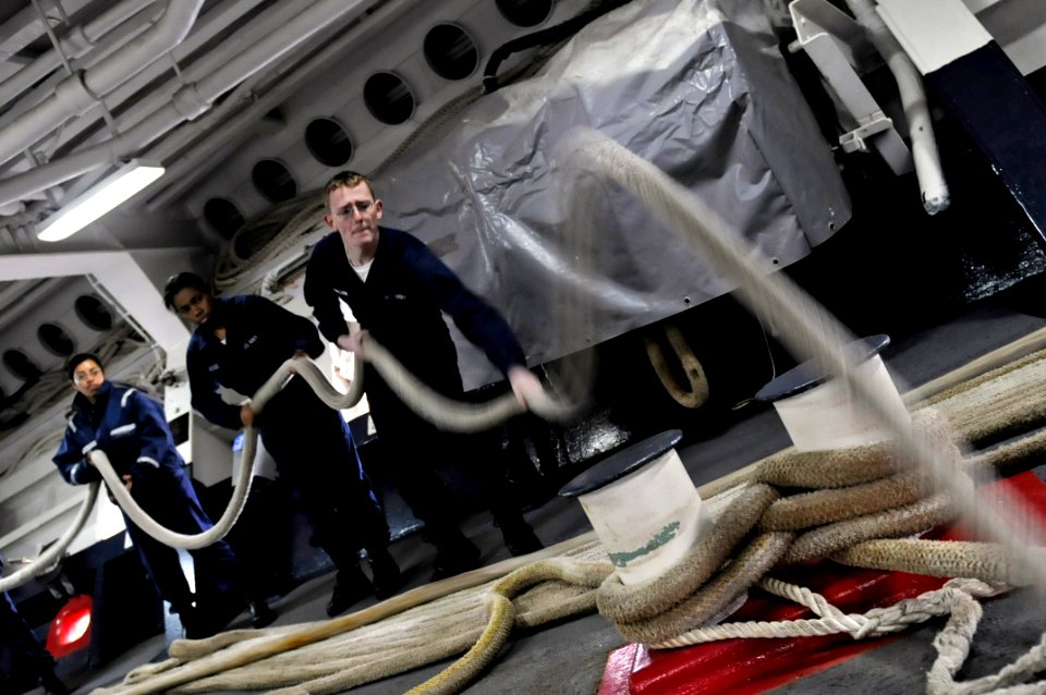 US Navy 090417-N-7280V-147 Seaman Johnathan Sobczak slacks off on the mooring line allowing line handlers on the pier to place it on the bollard and dip the eye as the amphibious command ship USS Blue Ridge (LCC 19) moors in Yo