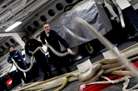 US Navy 090417-N-7280V-147 Seaman Johnathan Sobczak slacks off on the mooring line allowing line handlers on the pier to place it on the bollard and dip the eye as the amphibious command ship USS Blue Ridge (LCC 19) moors in Yo