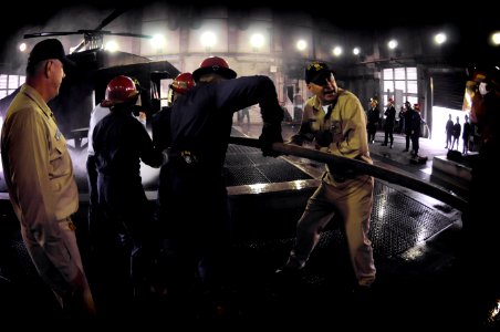 US Navy 090421-N-3830J-180 Lt. j.g. Jeffery Hanson, damage control assistant aboard the amphibious command ship USS Blue Ridge (LCC 19), demonstrates proper hose handling techniques to the flight deck fire party