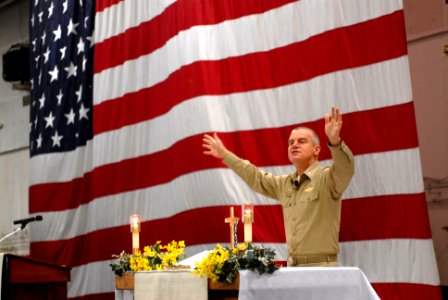 US Navy 090419-N-2344B-175 Cmdr. Lee Axtell delivers the benediction at a protestant service in the hangar bay aboard the aircraft carrier USS Ronald Reagan (CVN 76)