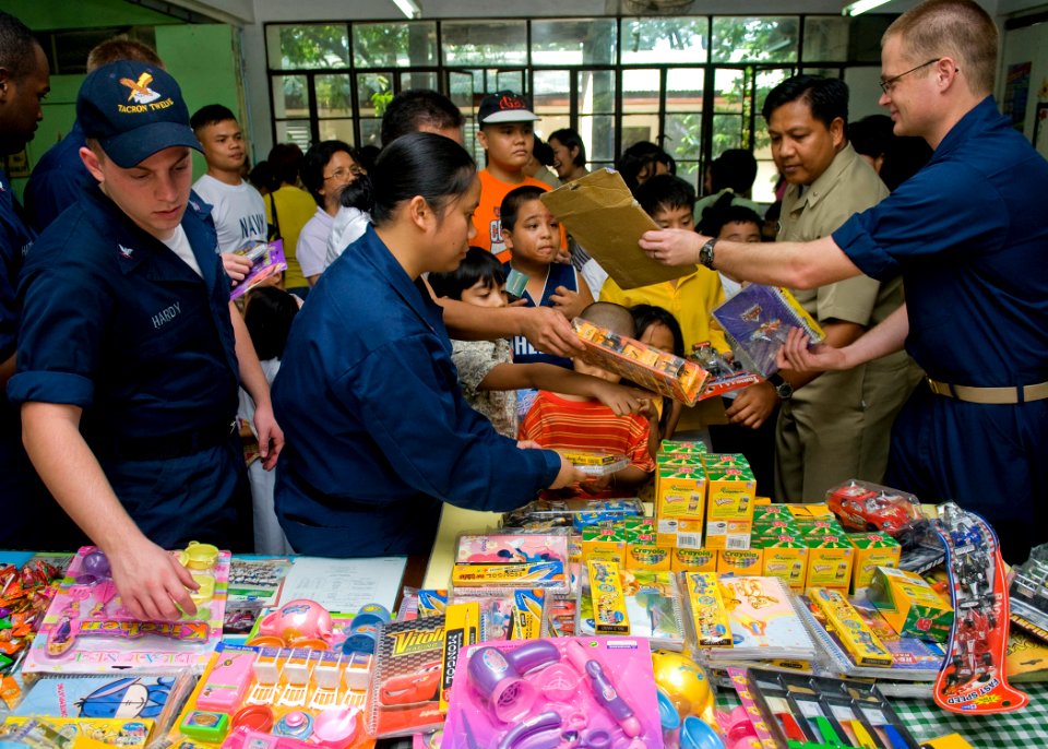 US Navy 090419-N-5253W-070 Sailors from Amphibious Squadron (PHIBRON) 11 and the Armed Forces of the Philippines Navy hand out toys