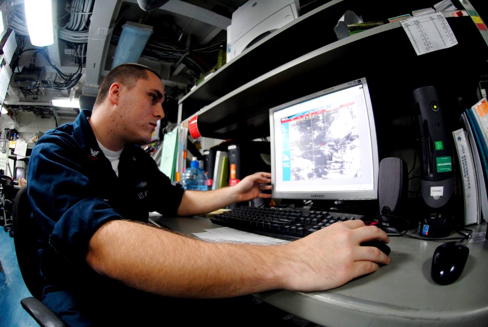 US Navy 090421-N-2475A-012 Aerographer's Mate 2nd Class Derron Gee, from East Hampton, N.Y., runs a satellite loop computer program used to predict weather patterns in the metrological shop aboard the aircraft carrier USS John