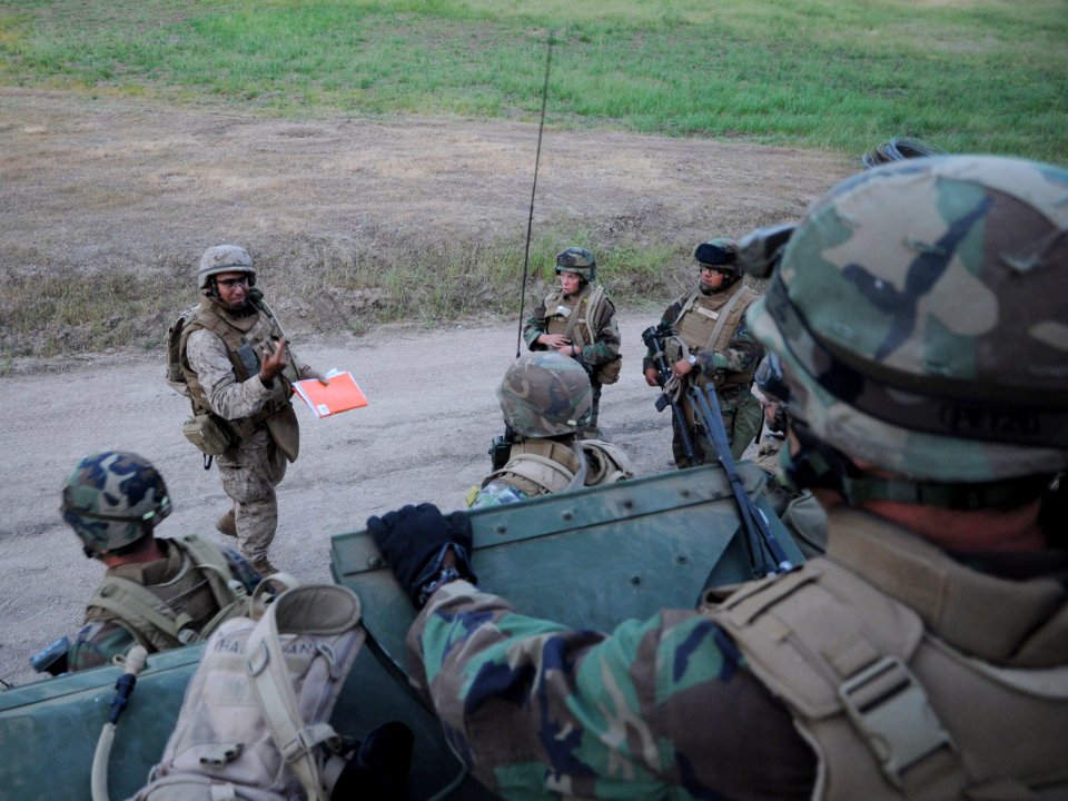 US Navy 090422-N-9584H-004 Gunnery Sgt. Jose Jaquez, a military advisor assigned to Naval Mobile Construction Battalion (NMCB) 3, debriefs Seabees assigned to NMCB-3 after a training scenario during Operation Bearing Duel 2009