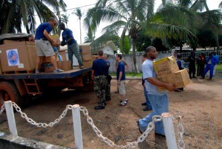 US Navy 090423-N-1688B-027 Quartermaster 3rd Class Marchello Fields, embarked aboard the amphibious transport dock ship USS Nashville (LPD 13), carries boxed supplies donated to Project Handclasp