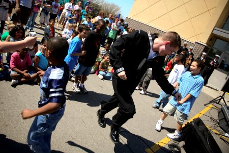 US Navy 090422-N-3271W-100 Musician Seaman Apprentice Steven Lamonica dances with children during a performance of the U.S. Navy Band Great Lakes