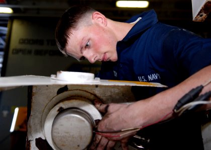 US Navy 090423-N-9520G-029 Aviation Support Equipment Technician Airman Ryan Dietsch, from Springfield, S.D. embarked aboard the amphibious assault ship USS Essex (LHD 2), performs corrosion treatment