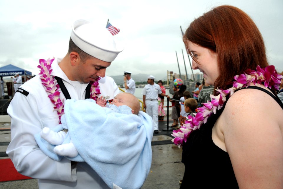 US Navy 090423-N-3666S-053 A Sailor assigned to the Arleigh Burke-class guided-missile destroyer USS Hopper (DDG 70) holds his newborn child