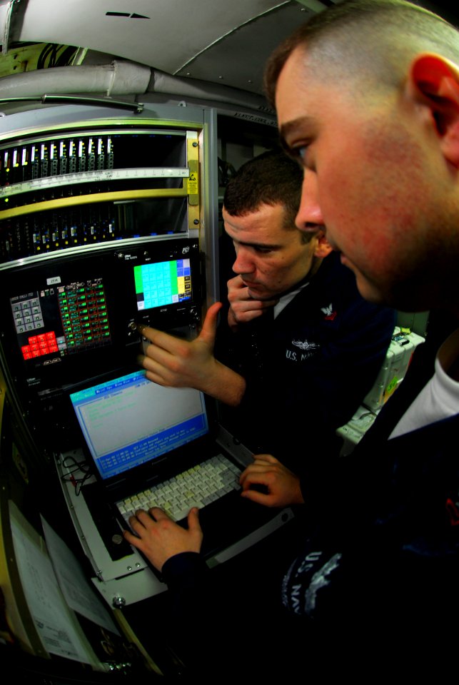 US Navy 090422-N-6597H-057 Electronics Technician 2nd Class Joshua Madura, right, from Sitka, Alaska, and Electronics Technician 2nd Class Christopher White, from Framer City, Ill., monitor the SSC-12 air traffic control commun