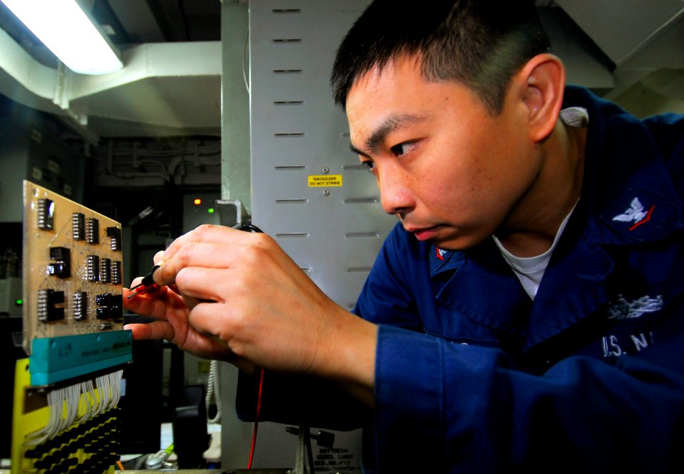 US Navy 090422-N-6597H-009 lectronics Technician 3rd Class Alvin Carrillo, from San Diego, performs diagnostic checks on the AN-SPN-41