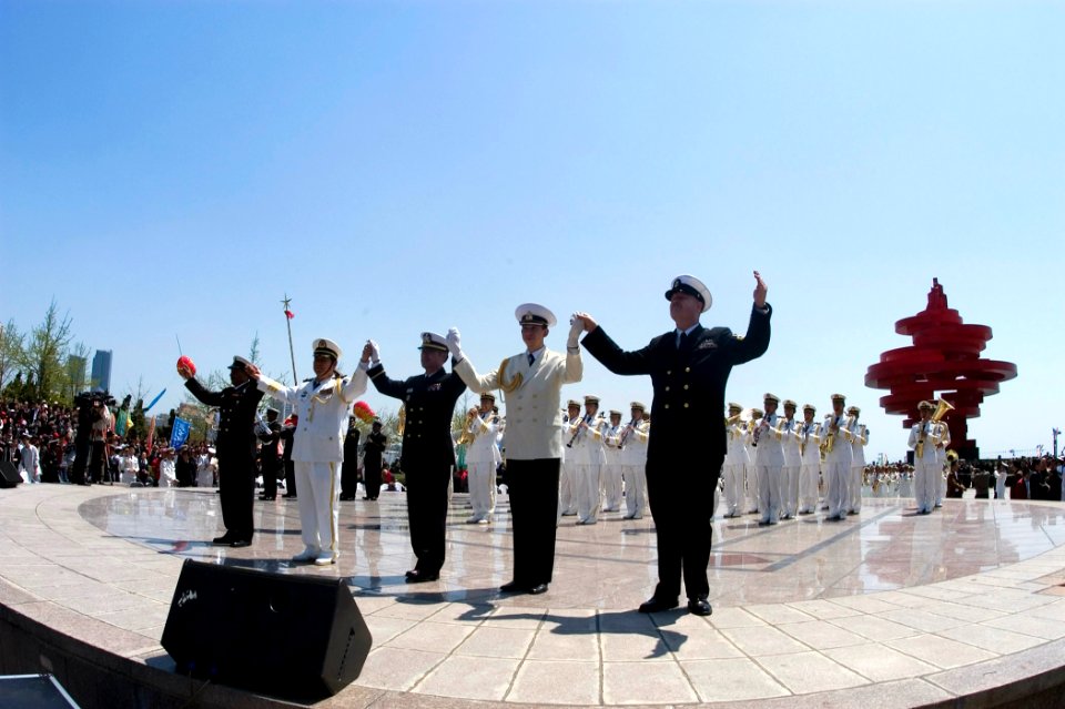 US Navy 090421-N-1251W-057 Senior Chief Musician Adam Vincent, right, joins hands with bandleaders from China, Russia, India, and South Korea