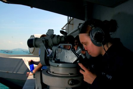 US Navy 090424-N-6597H-001 Quartermaster Seaman Britney Benigno, from Wichata Falls, Texas, stands the forward bearing watch on the island structure aboard the aircraft carrier USS John C. Stennis (CVN 74) as it transits Singap