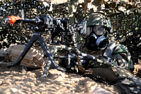 US Navy 090423-N-9584H-018 Builder 3rd Class Richard Snyder mans an M240B machine gun in his fighting position after a simulated chemical, biological, and radiological attack