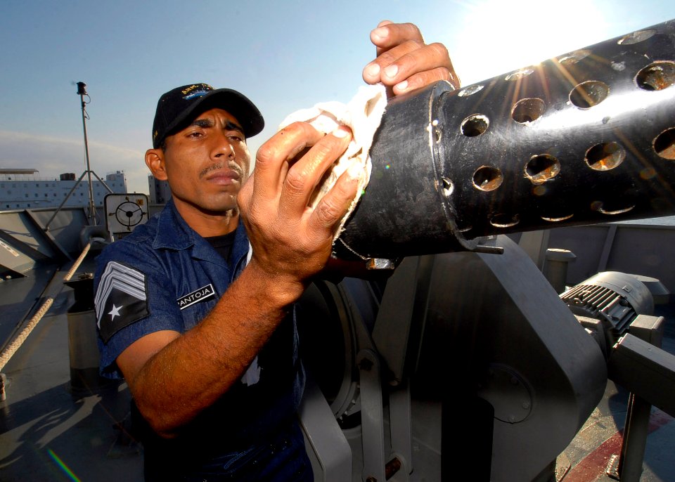 US Navy 090423-N-7092S-277 2-do Maestre Cuerpo General Condestable Damasio Pantoja Molina performs maintenance on the barrel of a 76-62mm cannon aboard the Mexican Navy ocean patrol ship ARM Oaxaca (PO-161)