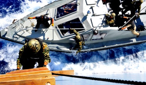 US Navy 090426-G-6464J-176 A Mexican Navy visit, board, search and seizure team member climbs a Jacob's ladder to the deck of the Federal Republic of Germany combat support ship Frankfurt am Main (AM 1412) during a boarding tra photo