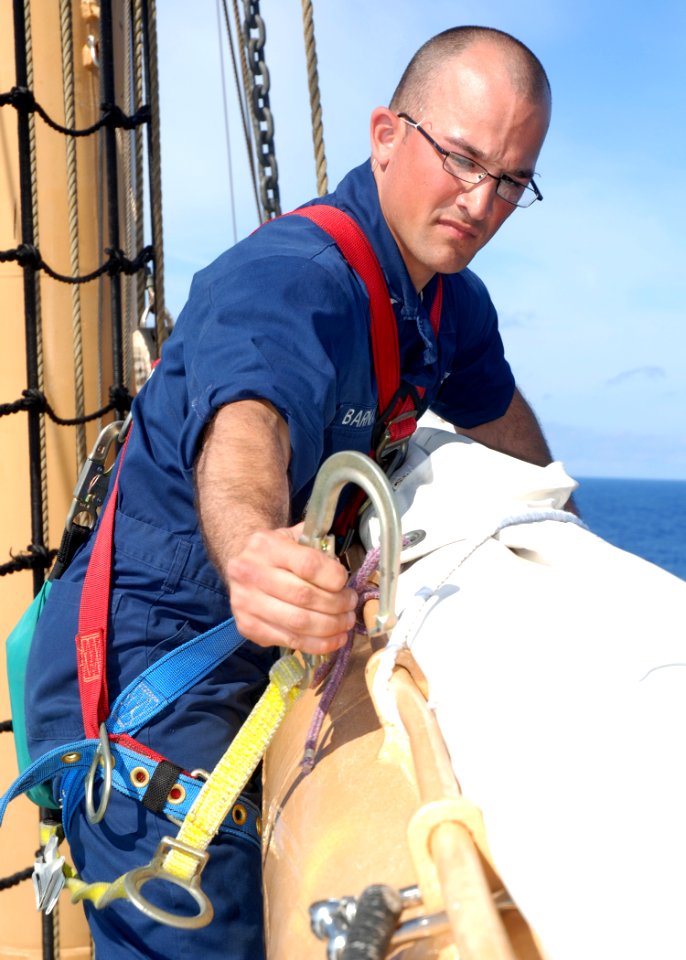 US Navy 090427-N-2893B-001 ATLANTIC OCEAN (April 27) - USS Constitution crewmember Aviation Electrician's Mate 2nd Class, Tony Barnardo, clips a safety harness onto the foremast topsail yard