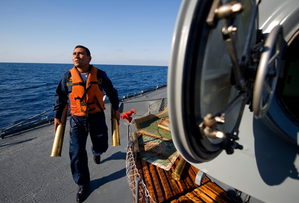 US Navy 090425-N-7090S-535 Waldemar Castillo gathers empty 76mm shells after the Colombian National Navy ship ARC Almirante Padilla (FM 51) participated in a live fire exercise during UNITAS Gold