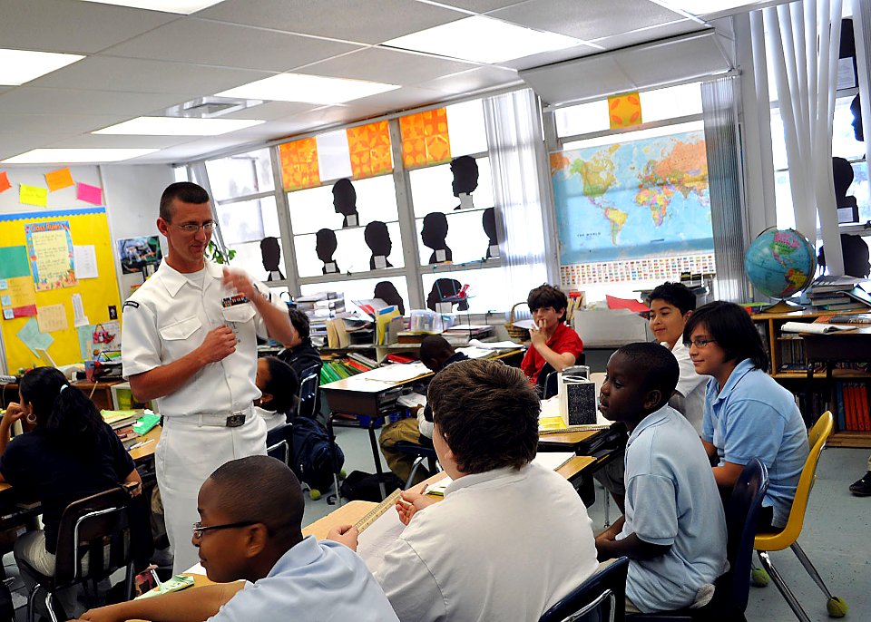US Navy 090428-N-4124C-002 Boatswains Mate 3rd Class William R. Scroggins, assigned to the guided-missile destroyer USS Forrest Sherman (DDG 98), speaks with fifth graders at Peters Elementary School during Fleet Week Port Ever